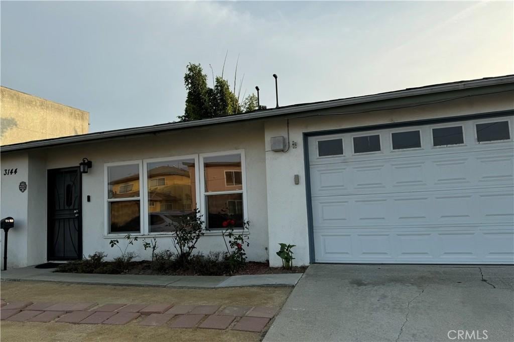 ranch-style home featuring a garage