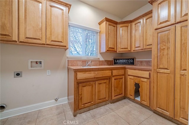 clothes washing area with cabinets, washer hookup, sink, hookup for an electric dryer, and light tile patterned flooring