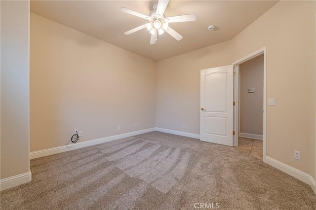 empty room featuring carpet floors and ceiling fan