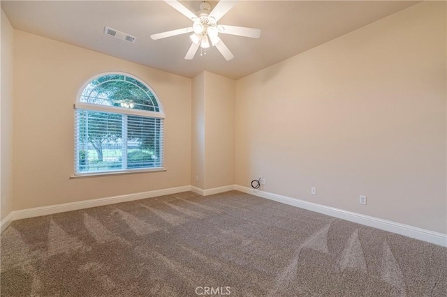 carpeted spare room with ceiling fan