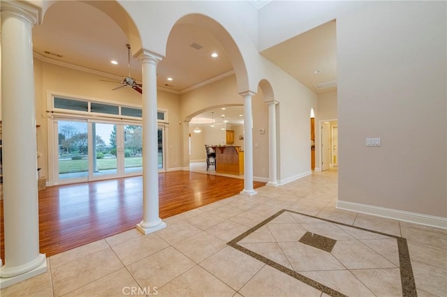 unfurnished room with ceiling fan, light tile patterned floors, and ornamental molding