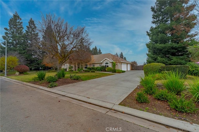 ranch-style house with a garage and a front lawn