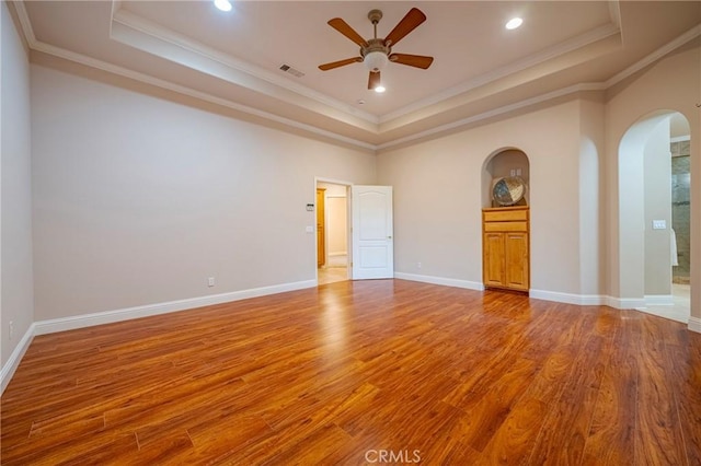 unfurnished room featuring ceiling fan, a tray ceiling, and ornamental molding