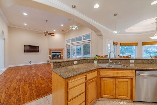 kitchen featuring dishwasher, sink, hanging light fixtures, ceiling fan, and stone counters