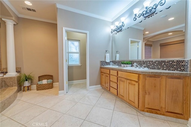 bathroom featuring tile patterned floors, vanity, ornate columns, decorative backsplash, and ornamental molding