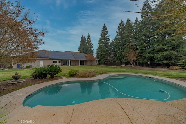 view of swimming pool with a yard