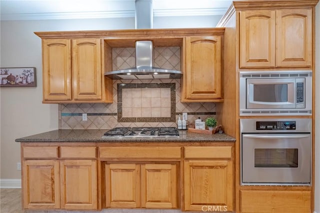 kitchen featuring stainless steel appliances, decorative backsplash, ornamental molding, and wall chimney range hood