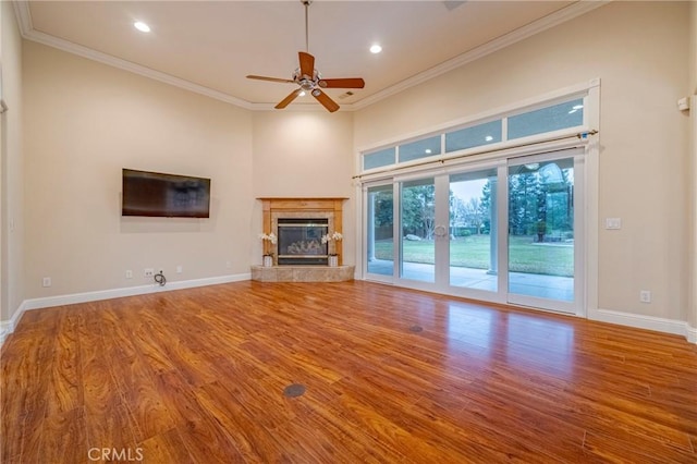 unfurnished living room featuring ceiling fan, crown molding, and hardwood / wood-style floors