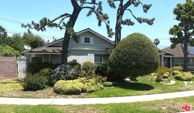 view of side of home featuring a yard