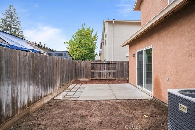 view of yard with central AC unit and a patio