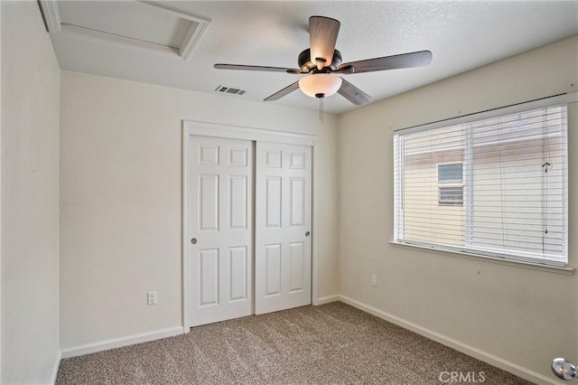 unfurnished bedroom with ceiling fan, light colored carpet, and a closet