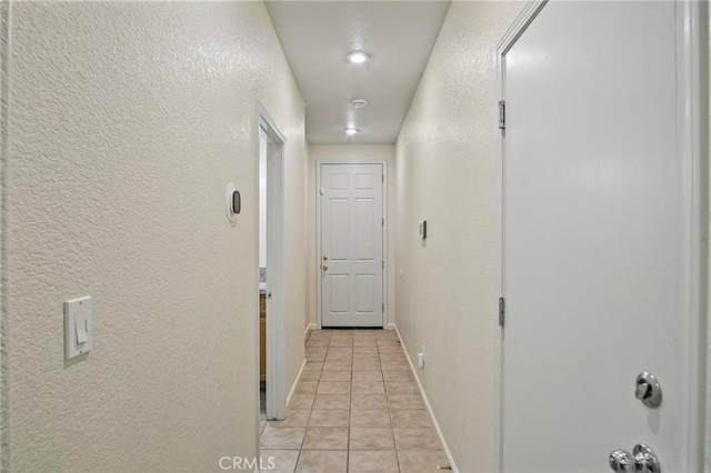 hall with light tile patterned floors