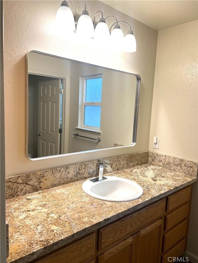 bathroom with a textured ceiling and vanity