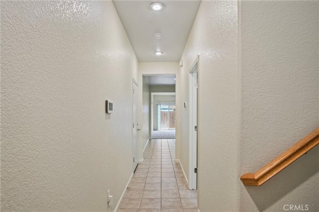 hall with light tile patterned floors