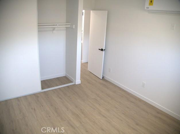 unfurnished bedroom featuring a closet and light hardwood / wood-style flooring