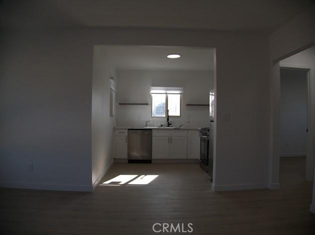 kitchen featuring white cabinets, appliances with stainless steel finishes, dark hardwood / wood-style floors, and sink