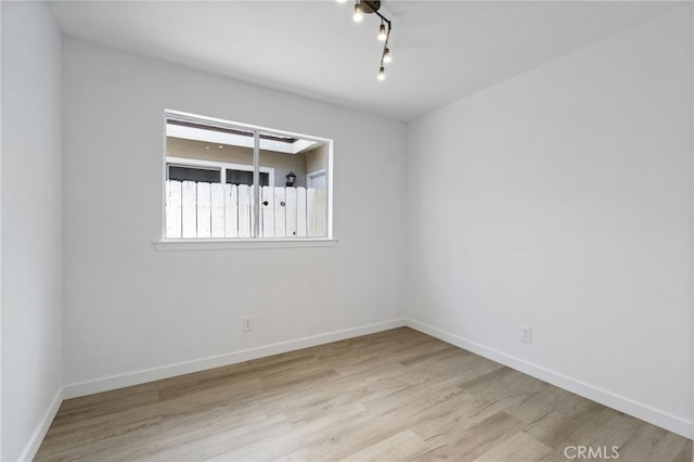 spare room with light wood-type flooring