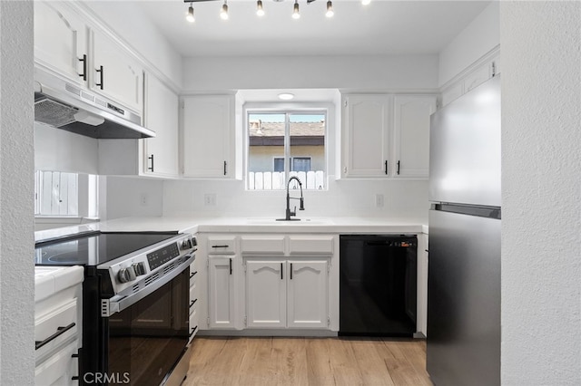 kitchen featuring light hardwood / wood-style floors, decorative backsplash, sink, white cabinetry, and stainless steel appliances