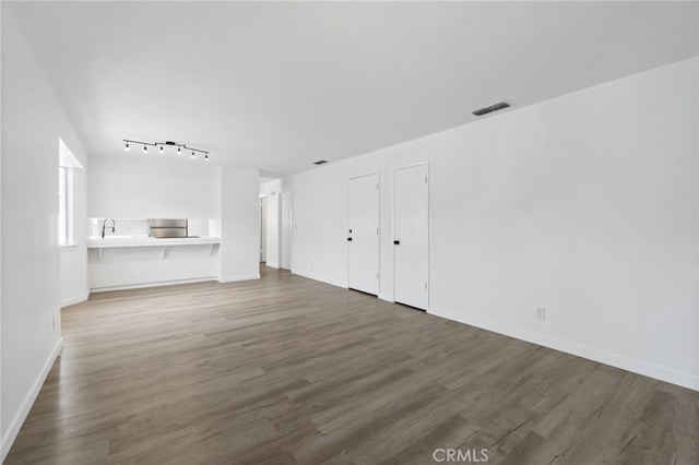 unfurnished living room featuring dark hardwood / wood-style floors