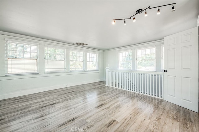 spare room featuring light hardwood / wood-style floors