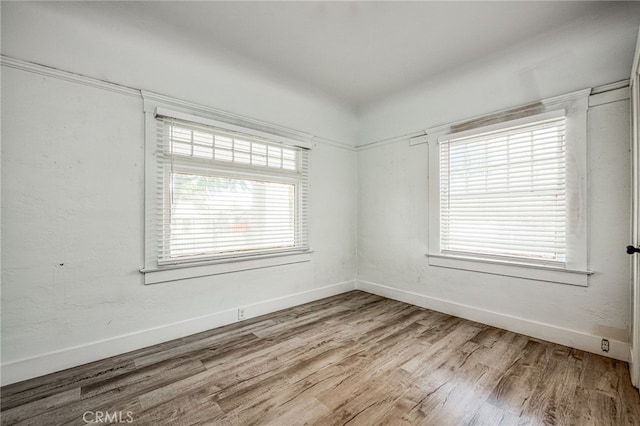 spare room with hardwood / wood-style floors