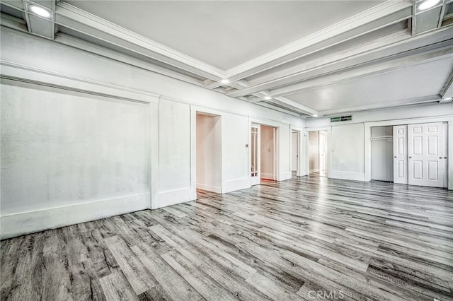 interior space with hardwood / wood-style floors and beamed ceiling