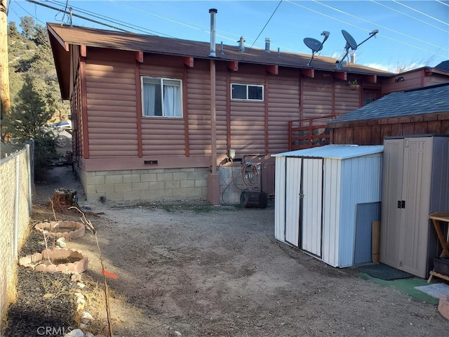 rear view of property with a shed