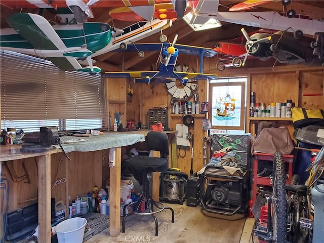 interior space with a workshop area and wooden walls