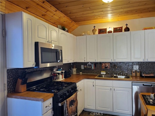 kitchen with white cabinetry, sink, stainless steel appliances, and wooden ceiling