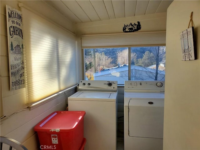 laundry area with washing machine and dryer and wood ceiling