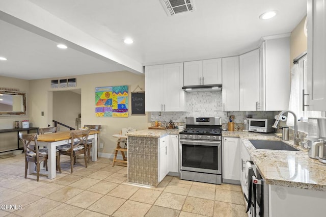 kitchen featuring white cabinetry, sink, light stone counters, and appliances with stainless steel finishes