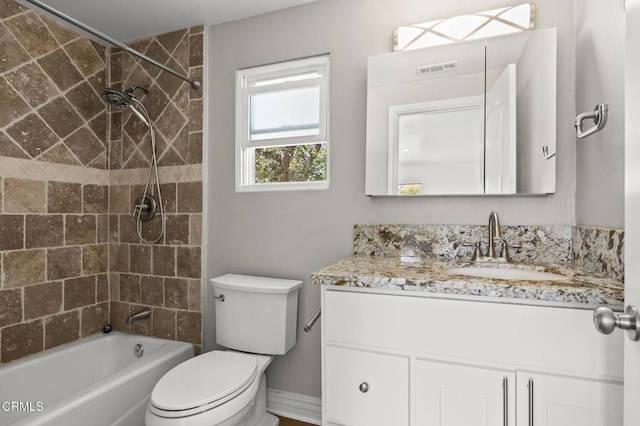 full bathroom with vanity, toilet, and tiled shower / bath combo