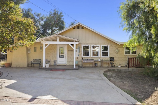 back of property with a patio