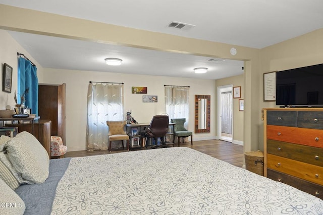 bedroom with dark hardwood / wood-style floors