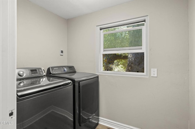 laundry room with a healthy amount of sunlight and washer and dryer