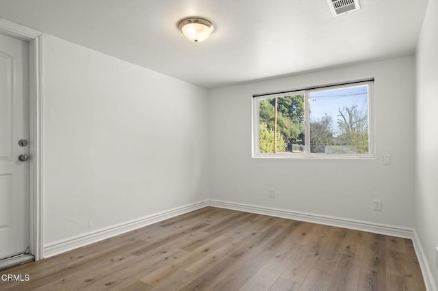 empty room with light hardwood / wood-style floors