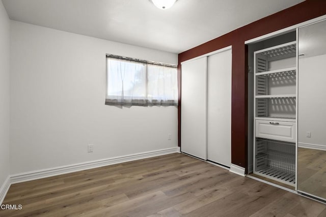 unfurnished bedroom with hardwood / wood-style floors