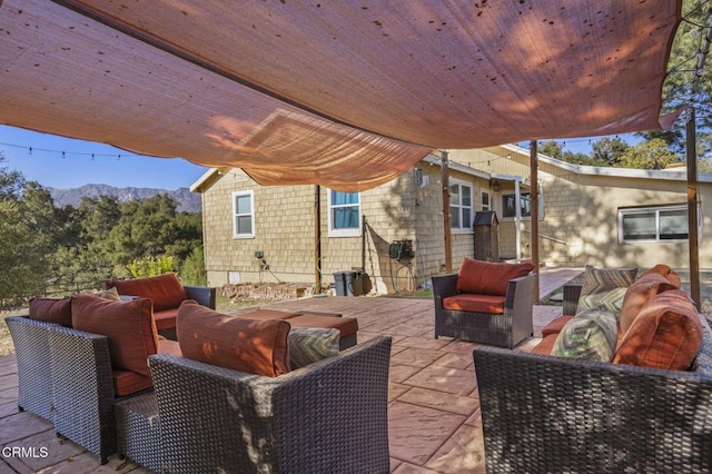 view of patio / terrace with a mountain view and an outdoor hangout area