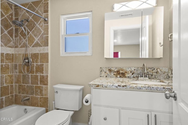 full bathroom with vanity, toilet, and tiled shower / bath combo