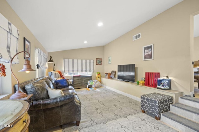 living room with vaulted ceiling and light colored carpet