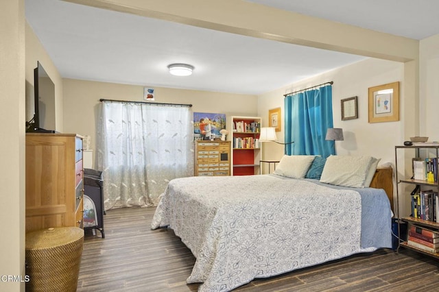 bedroom with dark wood-type flooring