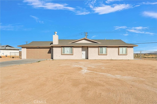 rear view of property featuring a garage