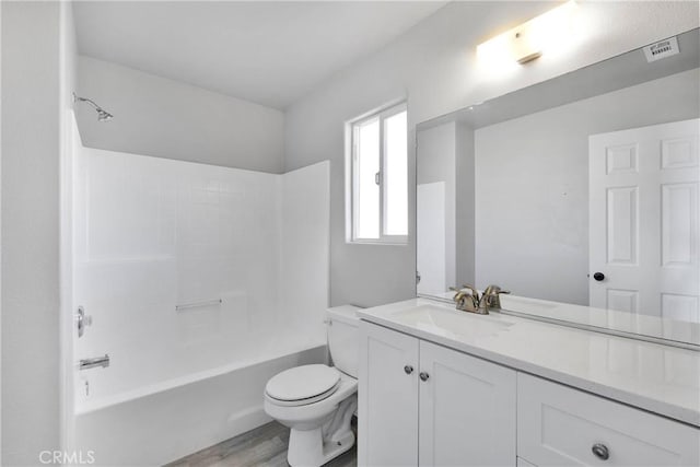 full bathroom featuring toilet, shower / bathtub combination, wood-type flooring, and vanity