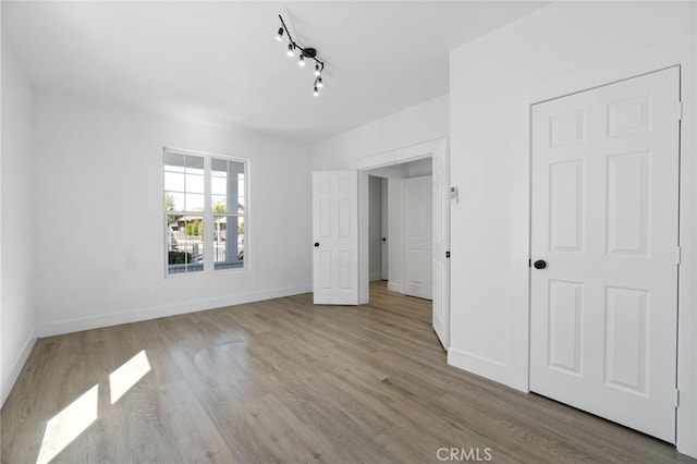 unfurnished bedroom with light wood-type flooring