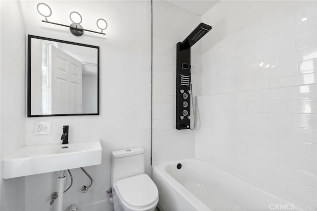 bathroom featuring toilet and tiled shower / bath combo