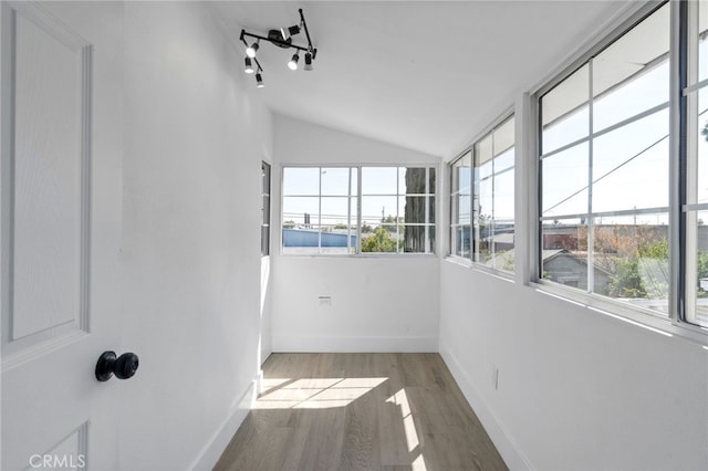 sunroom featuring lofted ceiling