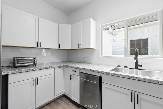 kitchen featuring backsplash, stainless steel dishwasher, sink, white cabinetry, and dark hardwood / wood-style flooring