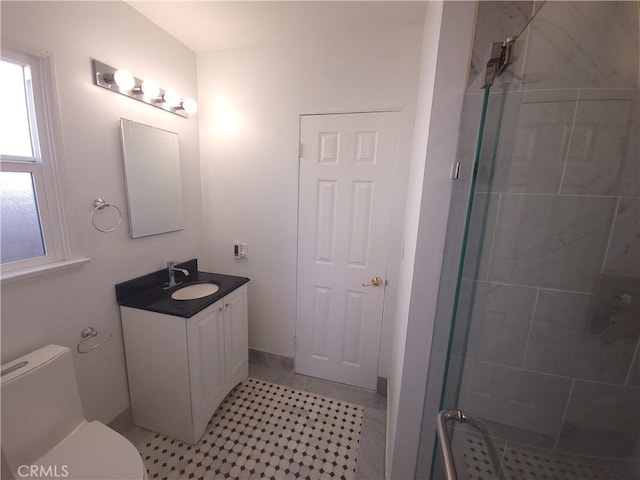 bathroom with vanity, toilet, and an enclosed shower