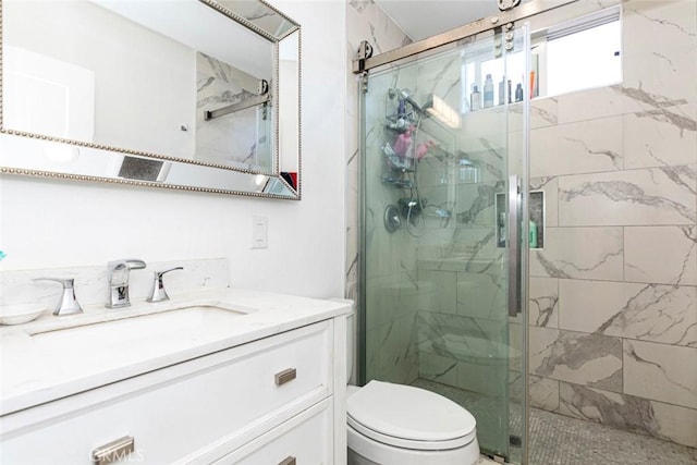 bathroom featuring an enclosed shower, vanity, and toilet