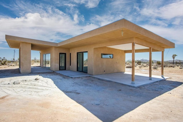 rear view of property featuring a patio area